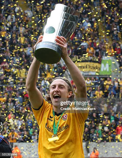 Michael Hefele of Dresden celebrates with the trophy after the third league match between SG Dynamo Dresden and SG Sonnenhof Grossaspach at DDV...