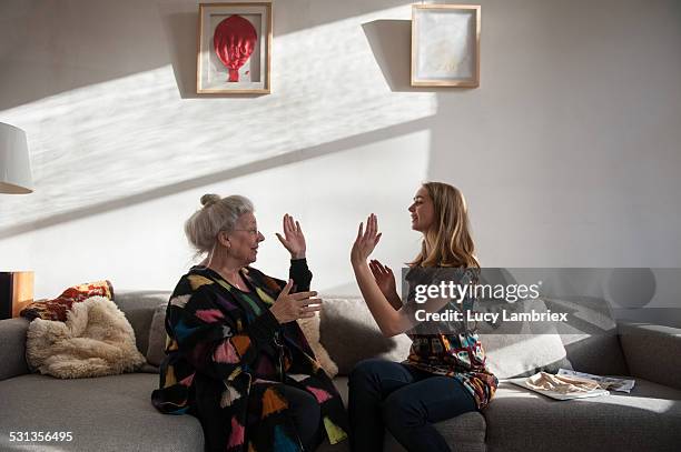 woman and grandmother hand clapping - candid photography stock pictures, royalty-free photos & images