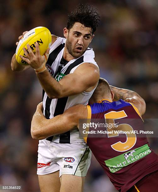 Alex Fasolo of the Magpies is tackled by Mitch Robinson of the Lions during the 2016 AFL Round 08 match between the Brisbane Lions and the...