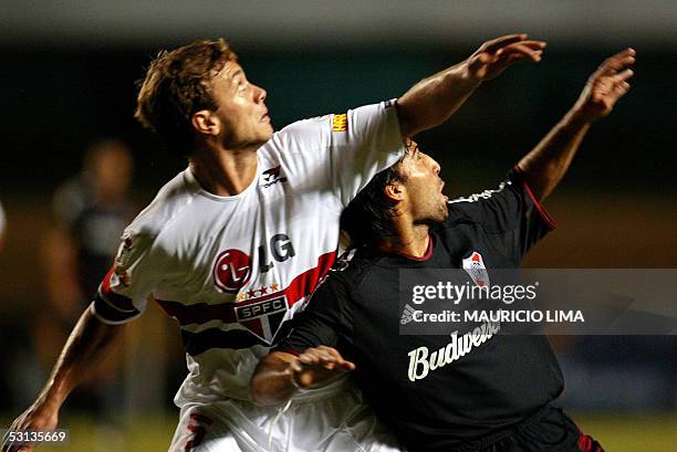 River Plate's Farias vies with Uruguayan Sao Paulo's Diego Lugano during their Libertadores Cup semifinal football match, held at Morumbi stadium, in...