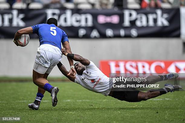 Samoa's Ed Fidow is tackled by Fiji's Josua Tuisova during a HSBC Paris Sevens Series rugby match between Fiji and Samoa at the Stade Jean Bouin in...