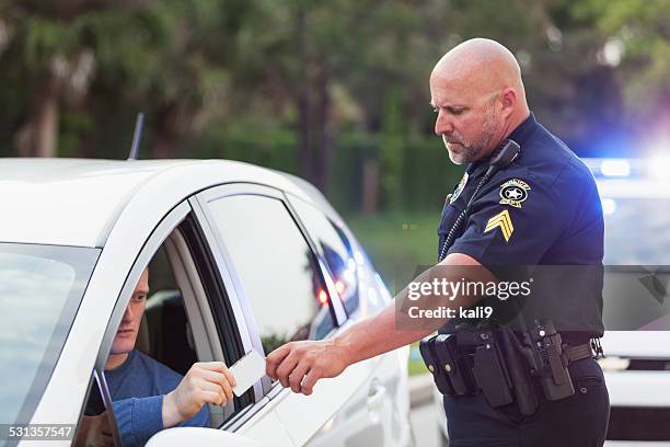 driver pulled over by police, giving id to officer - ticket stockfoto's en -beelden