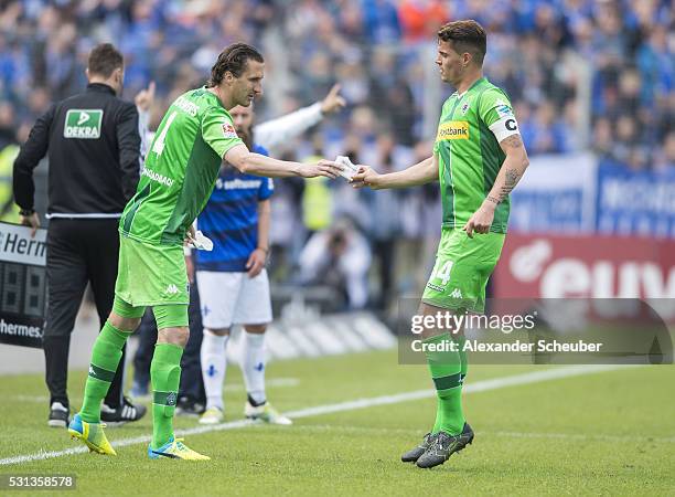 Granit Xhaka of Borussia Moenchengladbach gets a piece of paper by Roel Brouwers of Borussia Moenchengladbach during the first bundesliga match...