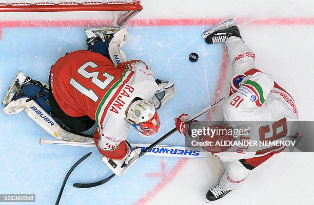 Belarus' forward Geoff Platt attacks Hungary's goalie Miklos Rajna during the group B preliminary round game Hungary vs Belarus at the 2016 IIHF Ice...