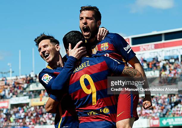 Luis Suarez of FC Barcelona celebrates scoring his team's first goal with his teamates Lionel Messi and Jordi Alba during the La Liga match between...