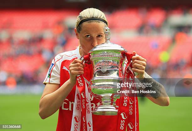 Kelly Smith of Arsenal kisses the trophy after the SSE Women's FA Cup Final between Arsenal Ladies and Chelsea Ladies at Wembley Stadium on May 14,...