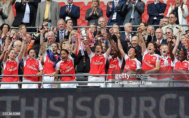 Alex Scott and Kelly Smith of Arsenal Ladies lift the FA Cup Trophy the after match between Arsenal Ladies and Chelsea Ladies at Wembley Stadium on...
