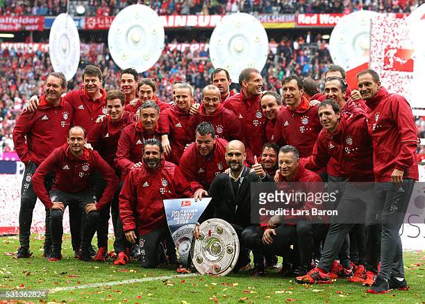 Head coach Josep Guardiola and staffs of Bayern Muenchen pose with the Meisterschale as they celebrate the Bundesliga champions after the Bundesliga...