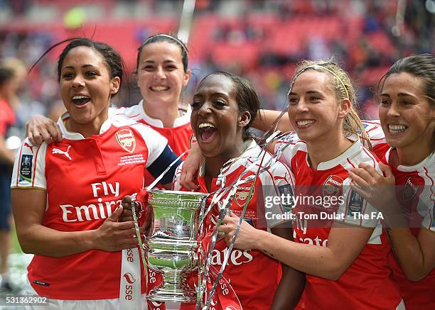 Alex Scott, Danielle Carter and Jordan Nobbs of Arsenal Ladies celebrate with the trophy after winning the SSE Women's FA Cup Final between Arsenal...