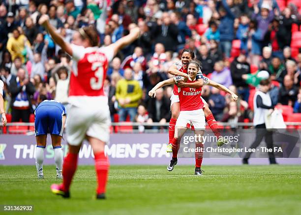 Alex Scott jumps on the back of Vicky Losada of Arsenal as they celebrate their victory during the SSE Women's FA Cup Final between Arsenal Ladies...