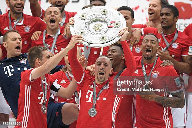 Franck Rebery of Bayern Muenchen lifts the Meisterschale as players and staffs celebrate the Bundesliga champions after the Bundesliga match between...