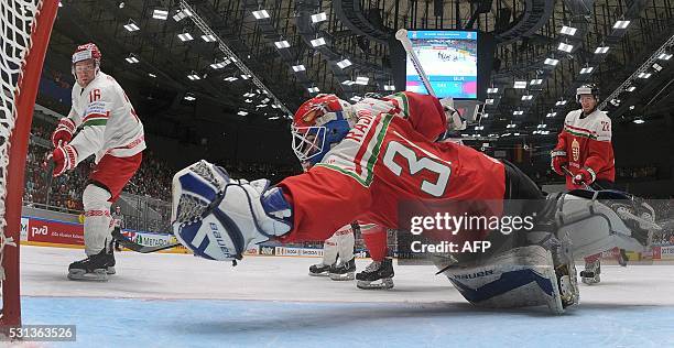Belarus' forward Geoff Platt attacks Hungary's goalie Miklos Rajna the group B preliminary round game Hungary vs Belarus at the 2016 IIHF Ice Hockey...