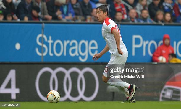 Jeong-Ho Hong of Augsburg runs with the ball during the Bundesliga match between FC Augsburg and Hamburger SV at SGL Arena on May 14, 2016 in...