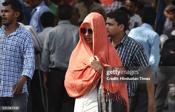 Woman walks with her face covered to protect herself from sun stroke on a hot summer day, on May 14, 2016 in New Delhi, India. The national capital...