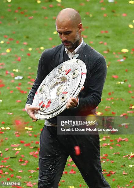 Josep Guardiola, coach of Bayern Muenchen carries the trophy after the Bundesliga after the Bundesliga match between FC Bayern Muenchen and Hannover...