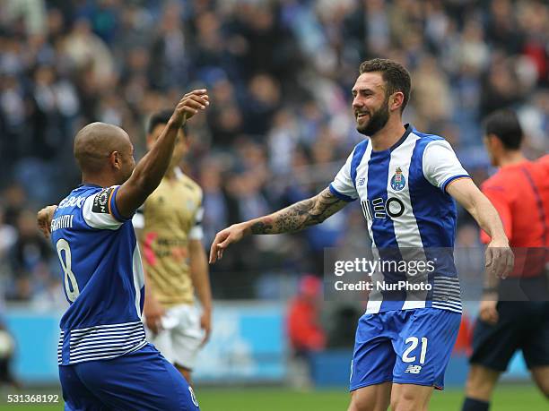 Porto's Mexican defender Miguel Lay��n celebrates after scoring goal with teammate Porto's Algerian forward Yacine Brahimi during the Premier League...
