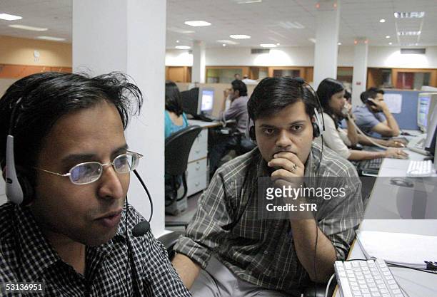 In this file picture taken 09 May 2005 in Mohali, in India's northern state of Punjab, Indian employees of a call center work during their night...