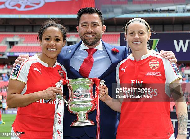 Alex Scott, Kelly Smith and Pedro Martinez Losa the Manager of Arsenal Ladies with the FA Cup Trophy after the match between Arsenal Ladies and...