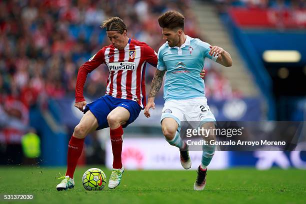Fernando Torres of Atletico de Madrid competes for the ball with Carles Planas of RC Celta de Vigo during the La Liga match between Club Atletico de...