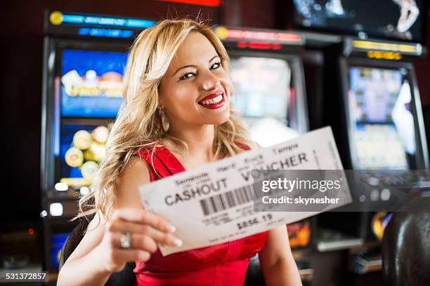 happy woman in a casino. - fruit machine stock pictures, royalty-free photos & images