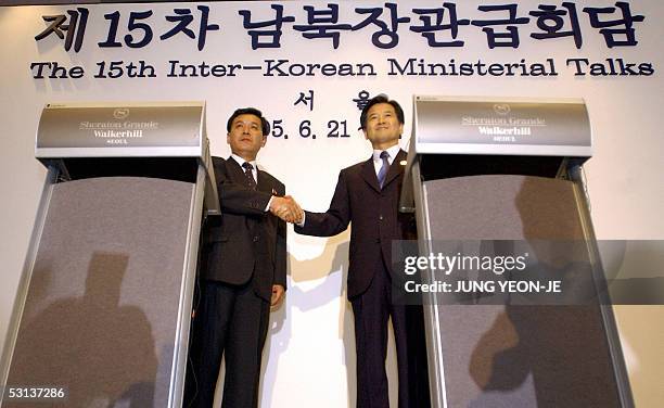 South Korean Unification Minister Chung Dong-Young shakes hands with North Korea's head delegate Kwon Ho-Ung at a joint press conference after their...