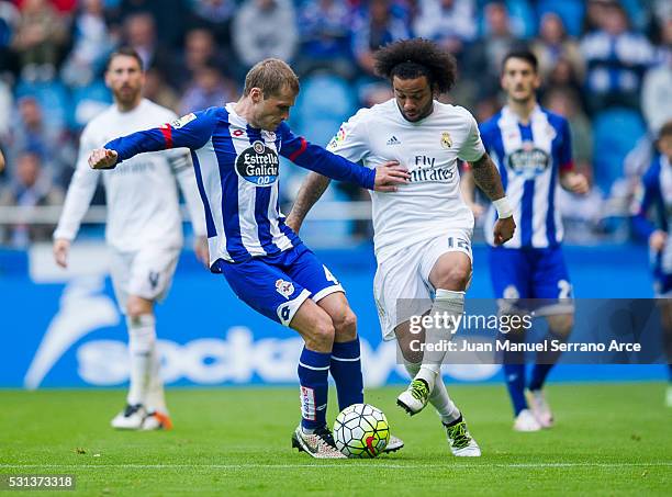 Marcelo Vieira da Silva of Real Madrid duels for the ball with Alex Bergantinos of RC Deportivo La Coruna during the La Liga match between RC...