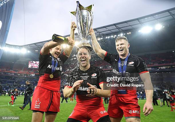 Alex Goode , Chris Wyles and Chris Ashton of Saracens celebrate with the trophy after the European Rugby Champions Cup Final match between Racing 92...