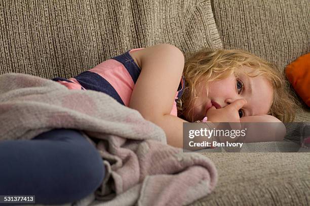 young girl sucking thumb - kuscheldecke stock-fotos und bilder