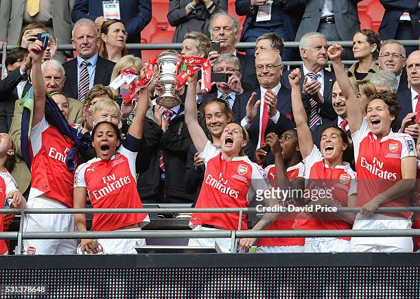 Alex Scott, Kelly Smith, Fara Williams and Josephine Henning of the Arsenal Ladies lift the FA Cup Trophy after the match between Arsenal Ladies and...