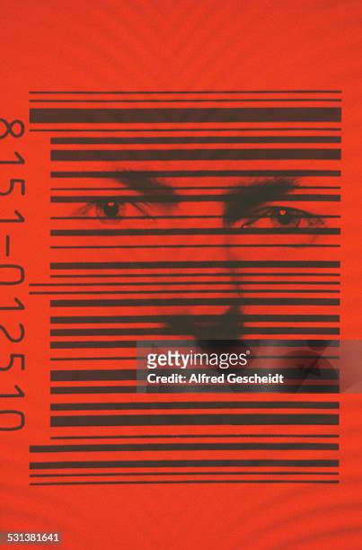 Human face behind the black bars of a barcode, 1982.