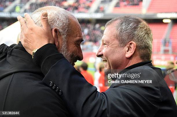 Rennes' French coach Rolland Courbis jokes with Bastia's French head coach Francois Ciccolini before the French L1 football match between Stade...