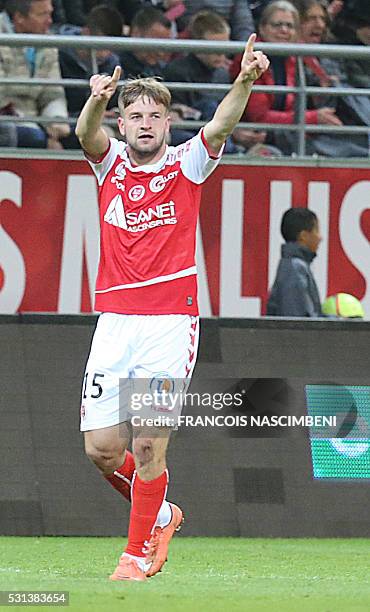 Reims' Franco-Turkish defender Atila Turan celebrates after scoring a goal during the French Ligue 1 football match between Reims and Lyon on May 14,...