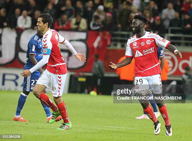 Reims' French forward Grejohn Kyei celebrates after scoring a goal during the French Ligue 1 football match between Reims and Lyon on May 14, 2016 at...