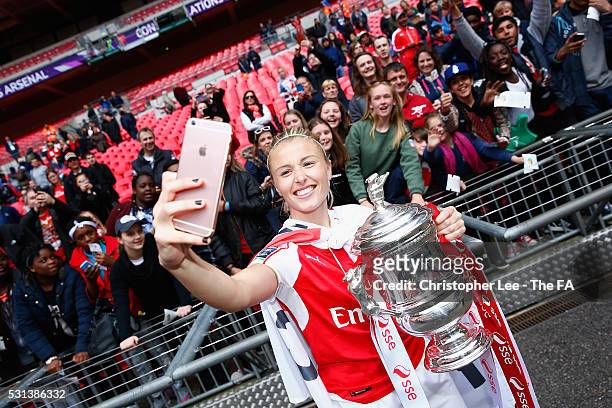 Leah Williamson of Arsenal takes a selfie on a fans phone with the fans and the FA Cup during the SSE Women's FA Cup Final between Arsenal Ladies and...