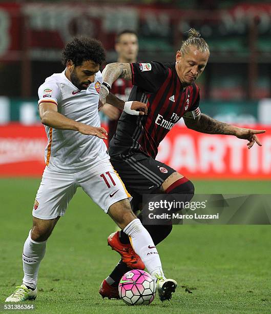 Mohamed Salah of AS Roma is challenged by Philippe Mexes of AC Milan during the Serie A match between AC Milan and AS Roma at Stadio Giuseppe Meazza...