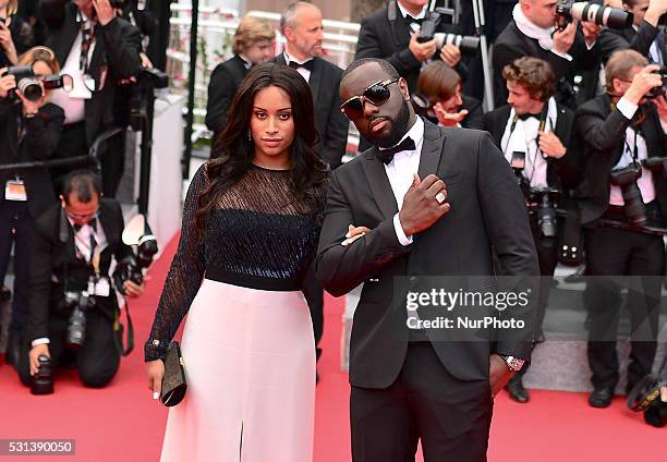 Congolese-born French rapper Maitre Gims and his wife DemDem pose on May 14, 2016 as they arrive for the screening of the film 'The BFG' at the 69th...