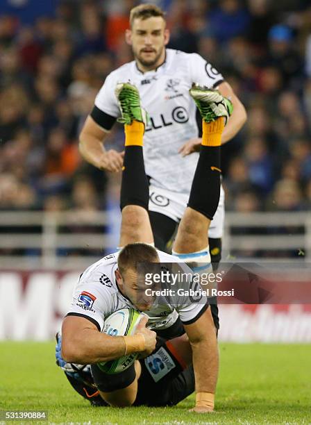 Coenie Oosthuizen of Sharks is tackled by Matias Alemanno of Jaguares during a match between Jaguares and Sharks as part of Super Rugby 2016 at Jose...