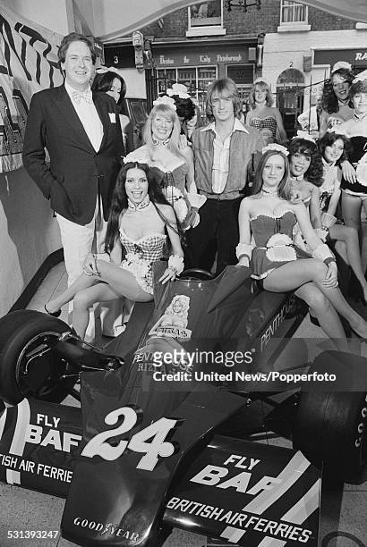 Owner of Hesketh Racing, Lord Alexander Fermor-Hesketh pictured with English Formula 1 racing driver Rupert Keegan and various Penthouse Pets sitting...