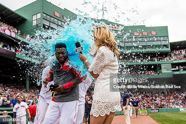 David Ortiz of the Boston Red Sox reacts as he is given a Powerade bath alongside NESN reporter Guerin Austin after hitting a game winning walk-off...