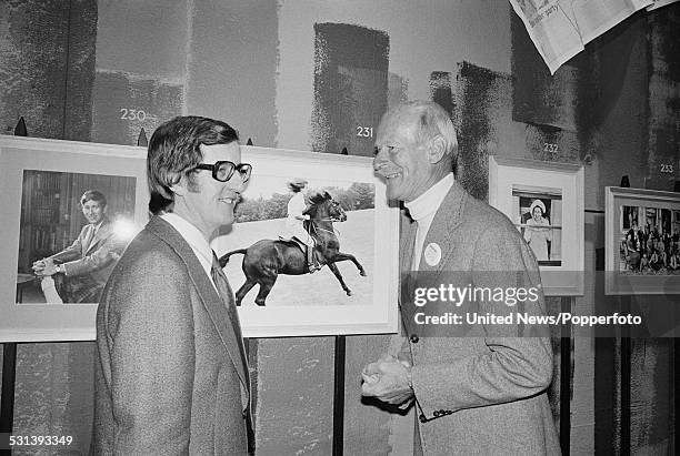 English photographer Norman Parkinson pictured on right with Colin Ford, curator of film and photography at the National Portrait Gallery during a...