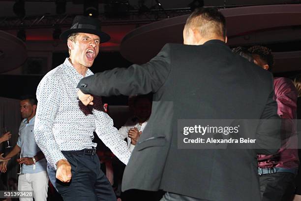 Thomas Muller dances as Music band, OneRepublic performs at the FC Bayern Muenchen Bundesliga Champions Dinner at the Postpalast on May 14, 2016 in...