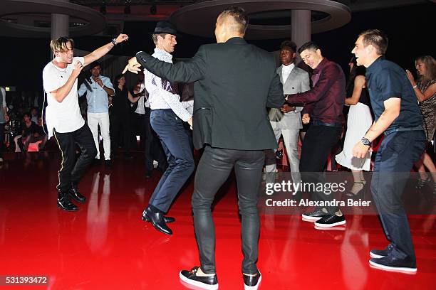 Thomas Muller, Robert Lewandowski, Philipp Lahm and Rafinha dance as music band, OneRepublic performs at the FC Bayern Muenchen Bundesliga Champions...