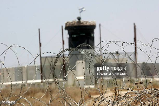 An Israeli flag flies over a watchtower at an Israeli Army checkpoint outside the Jewish settlement of Gush Katif settlement June 23, 2005 in the...