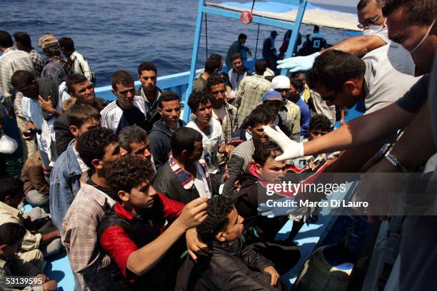 Italian custom Police "Guardia di Finanza" Officers take on board illegal Immigrants on June 21, 2005 in Lampedusa, Italy. Tens of thousands of...