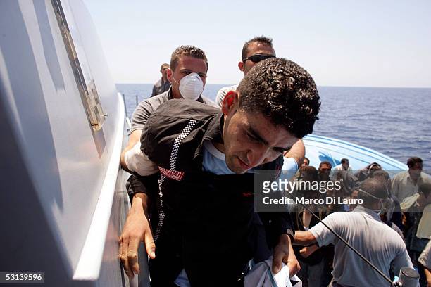 Italian custom Police "Guardia di Finanza" Officers take on board illegal Immigrants on June 21, 2005 in Lampedusa, Italy. Tens of thousands of...