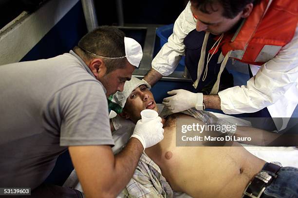 An Italian custom Police "Guardia di Finanza" Officer and an Italian Navy doctor tend to an unconcious illegal immigrant after he was taken on board...