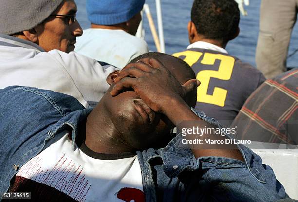 An Illegal Immigrant is seen on a boat of Italian custom Police "Guardia di Finanza" after he was taken on board on June 21, 2005 in Lampedusa,...