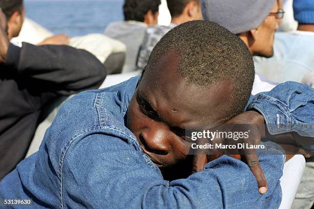 An Illegal Immigrant is seen on a boat of Italian custom Police "Guardia di Finanza" after he was taken on board on June 21, 2005 in Lampedusa,...