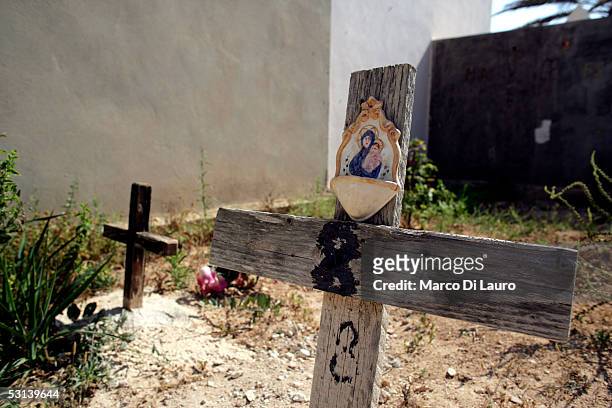Graves with no names of unknown illegal immigrants who were found dead in the sea in the outskirt of Lampedusa or who died on a boat trying to reach...