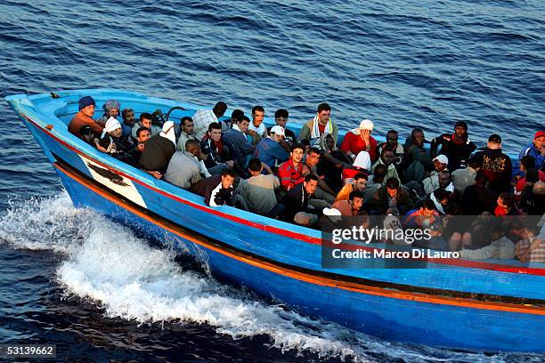 Boat loaded with illegal immigrant is seen on June 21, 2005 in Lampedusa, Italy. Tens of thousands of immigrants land on the Italian coast each year,...